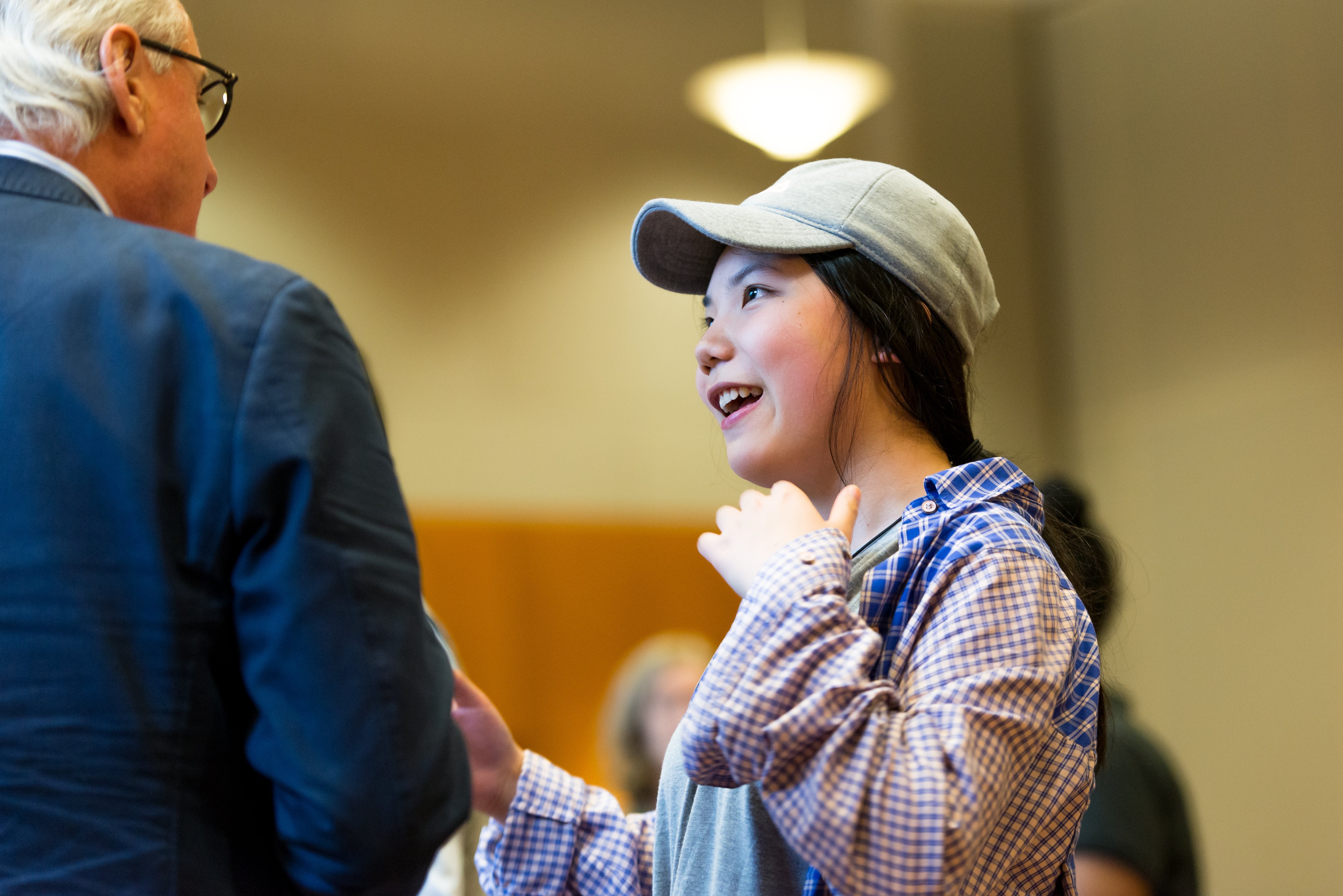 Student speaking to a person in a suit.