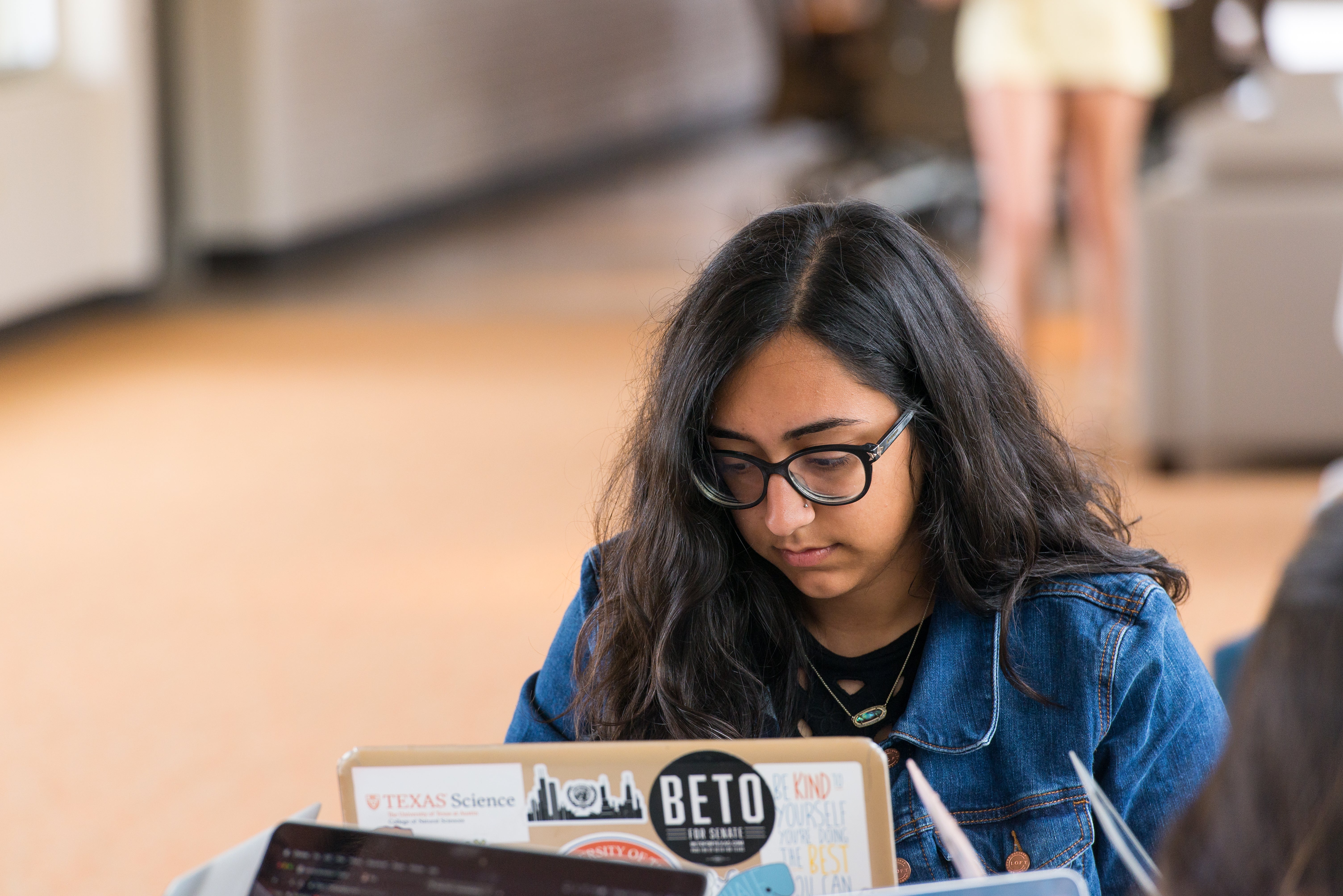 Student looking at a laptop computer.