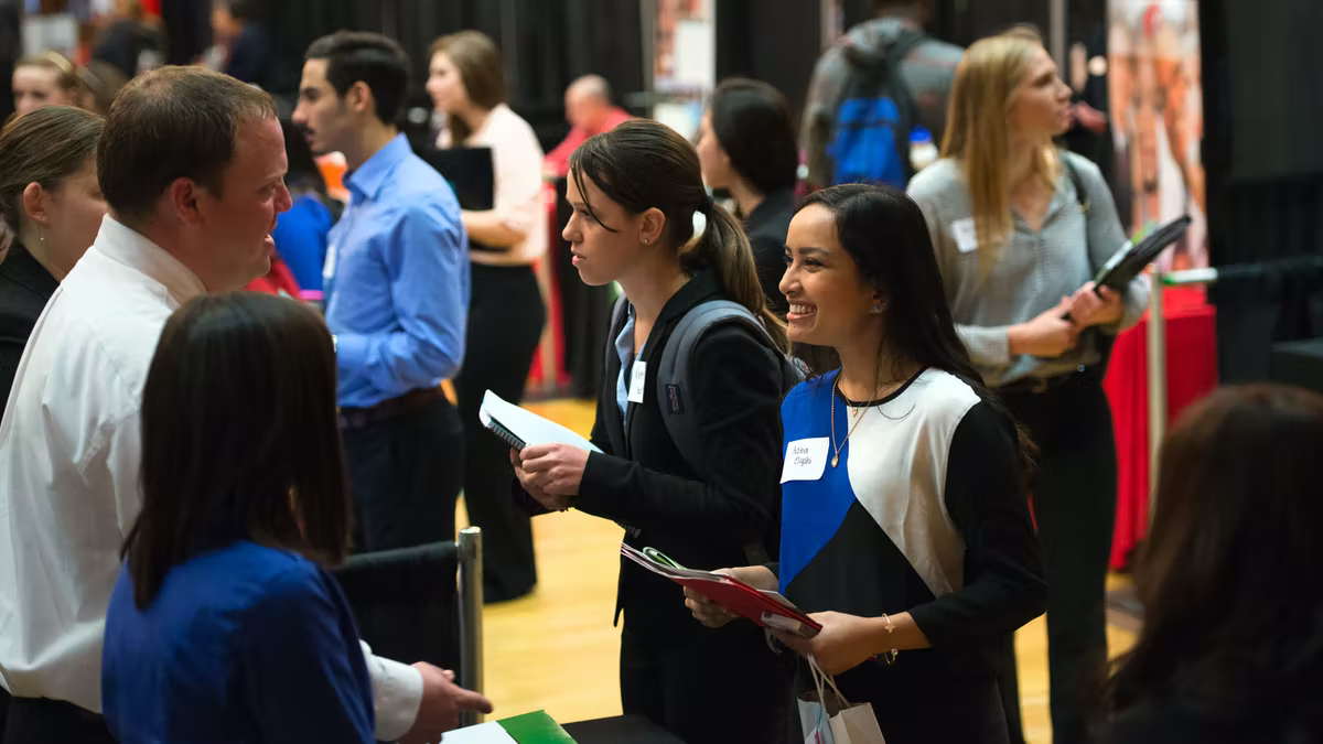 students talking to employers at a career fair