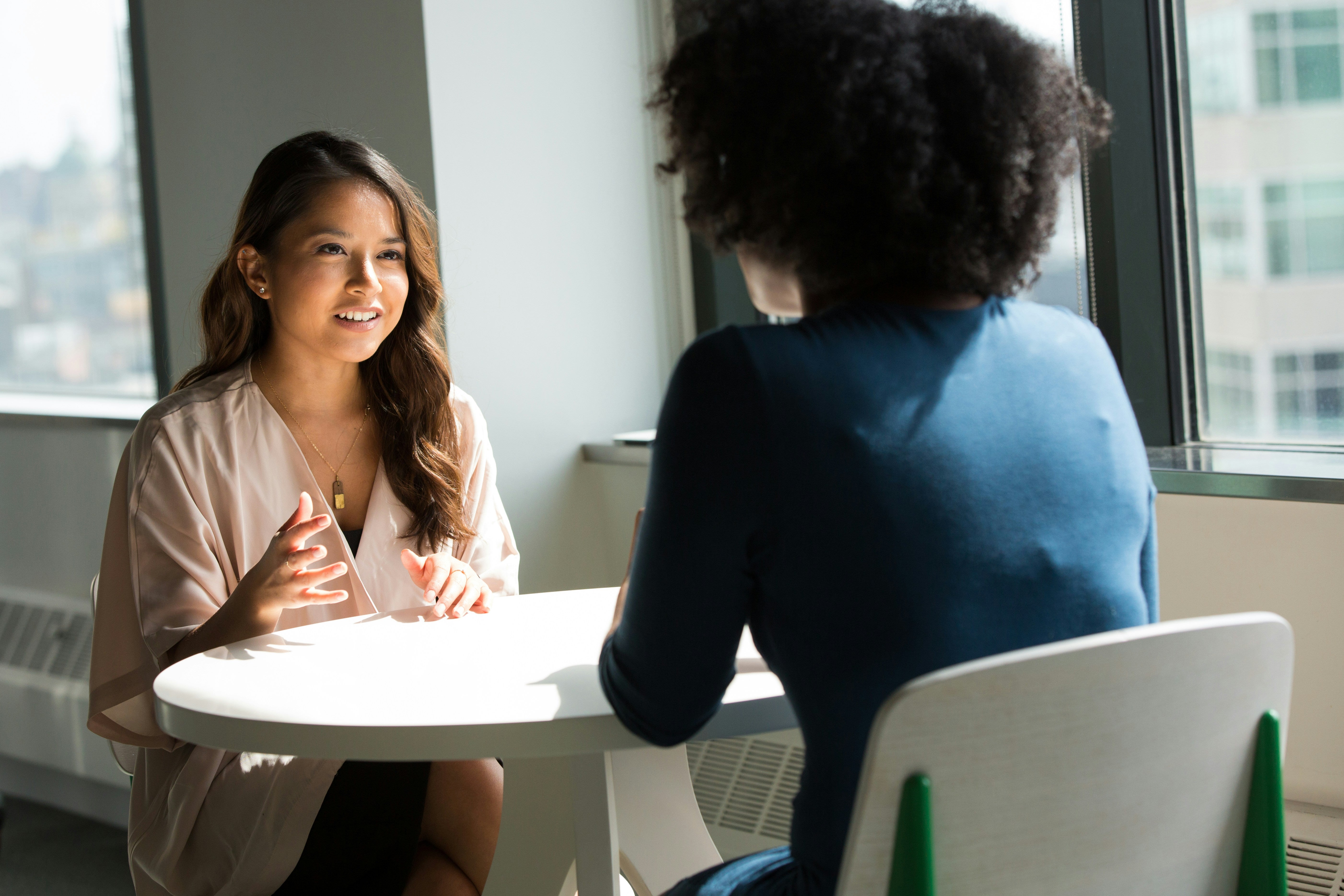 Recruiter and student casually networking at a table